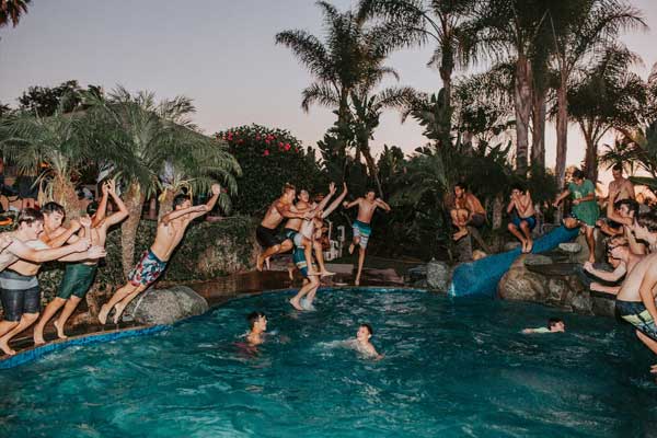 people jumping into pool